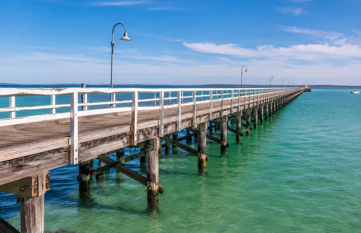Stansbury Jetty extending over the clear water of Oyster Bay