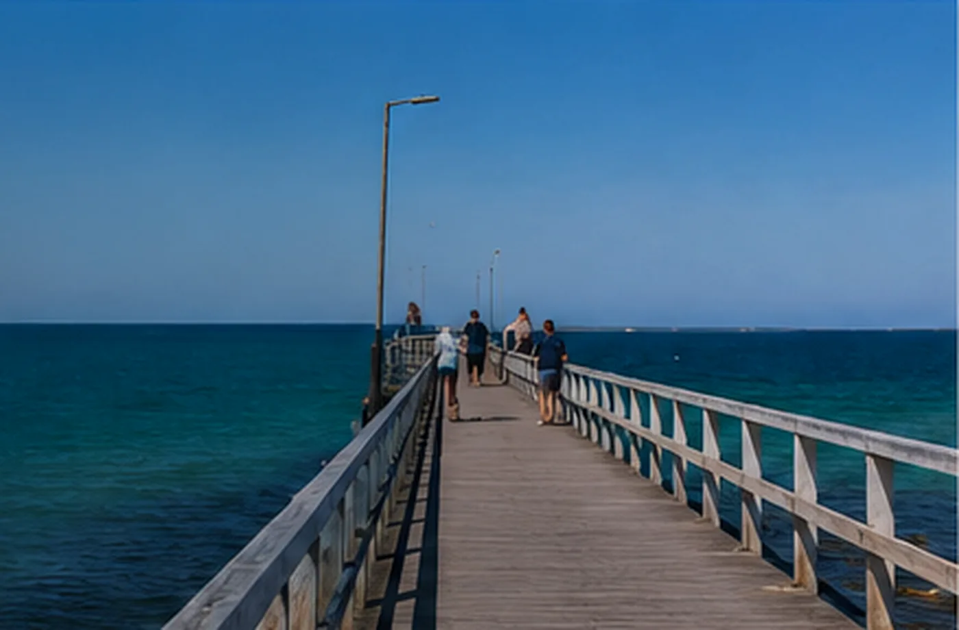 Visitors walking along Stansbury Jetty above the sheltered water of Oyster Bay