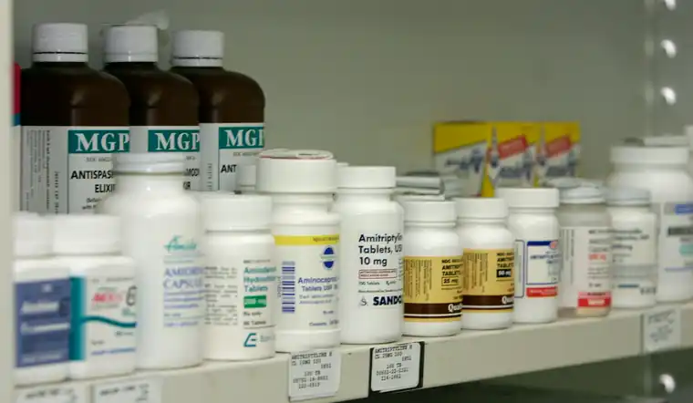 Medicine bottles arranged on pharmacy shelves