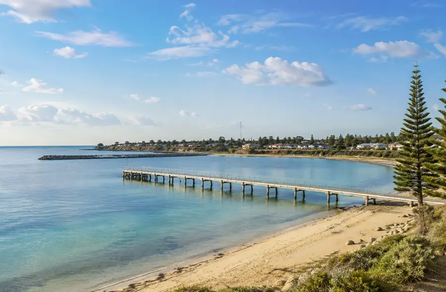 Stansbury foreshore with calm bay, jetty and Norfolk pines