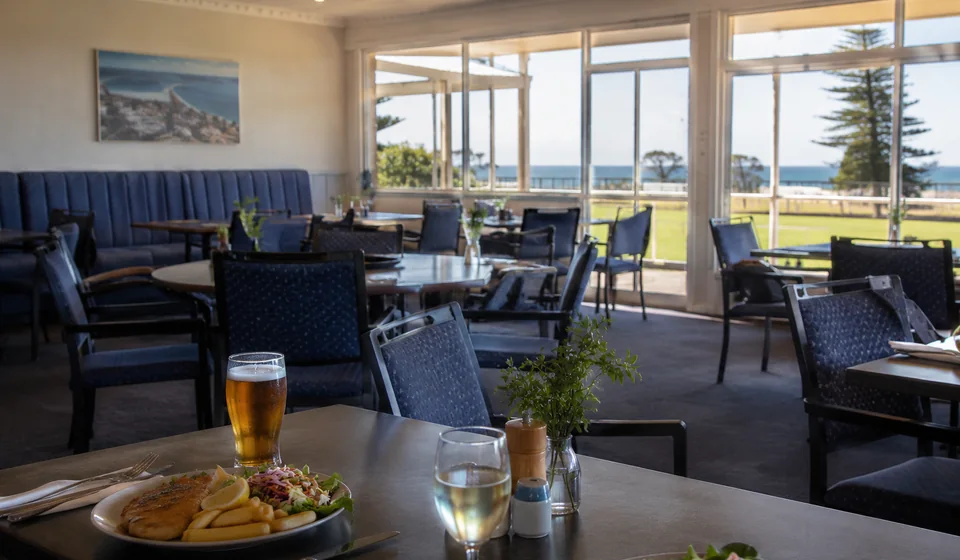 Relaxed coastal community dining room with meals and bay views