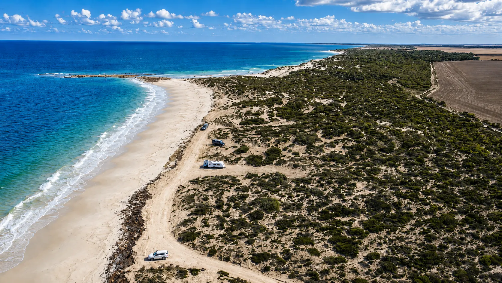 Aerial view of coastal Yorke Peninsula showing beach, dunes, camping track and inland farmland