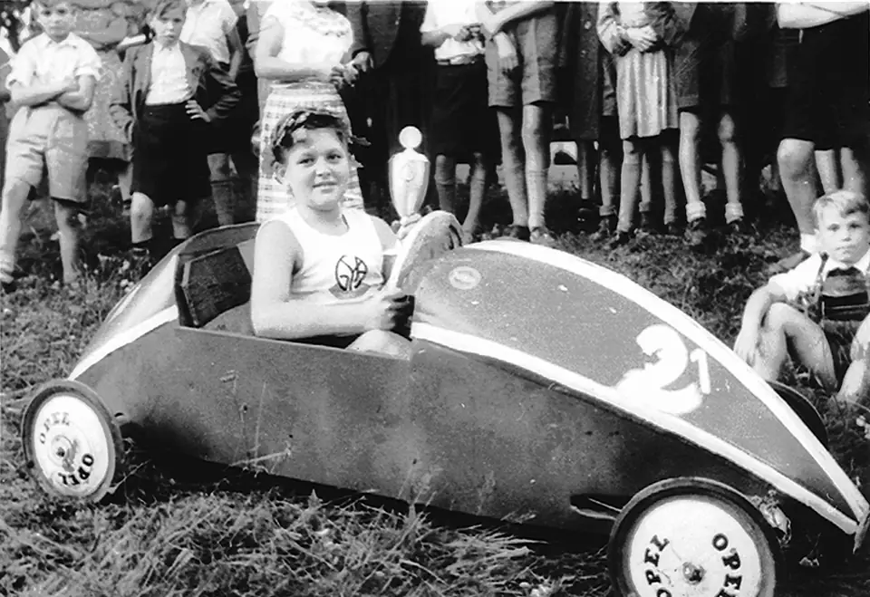 Children at a 1950 soap box derby with a low gravity-powered racer